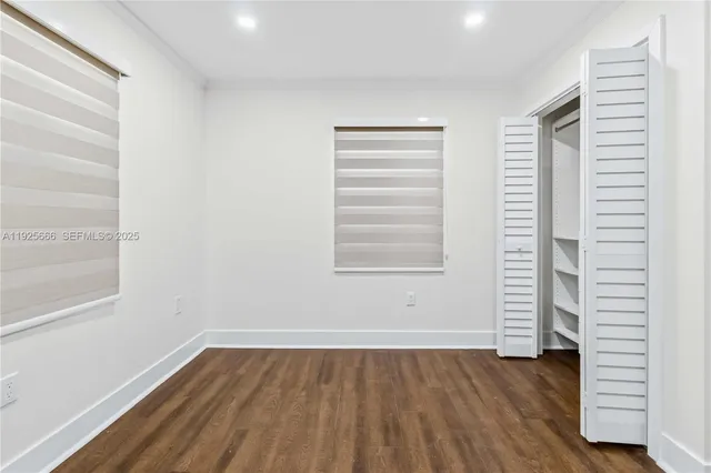 a view of wooden floor and windows in a room