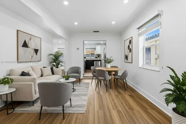 a living room with furniture and a potted plant