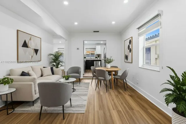 a living room with furniture and a potted plant