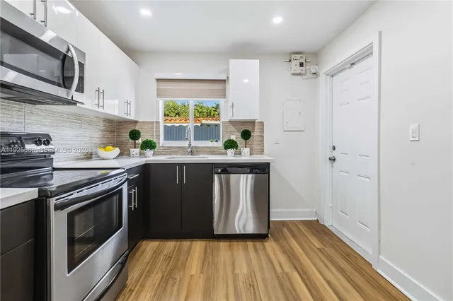 a kitchen with a sink stove and refrigerator