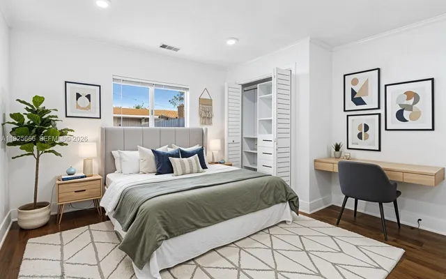 a bedroom with a bed and a painting on the wall