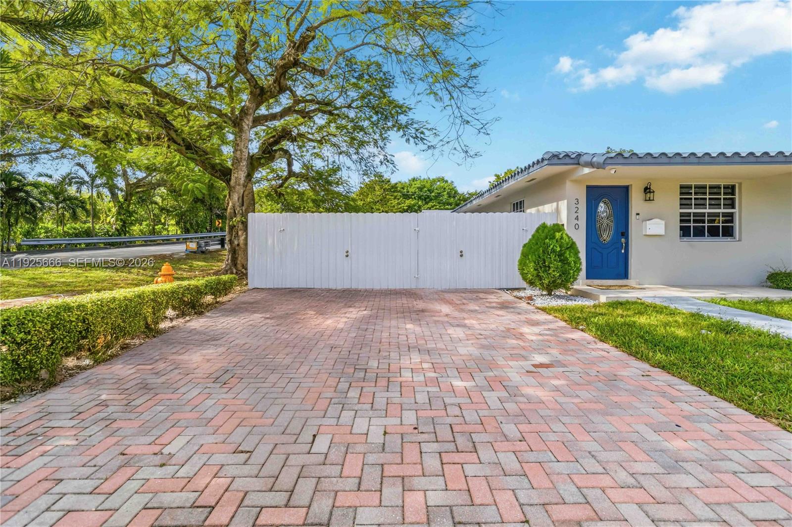 3240 Southwest 69th Avenue, Unit 2 Miami, FL 33155 - Photo 10 of 26 a front view of a house with a yard and potted plants
