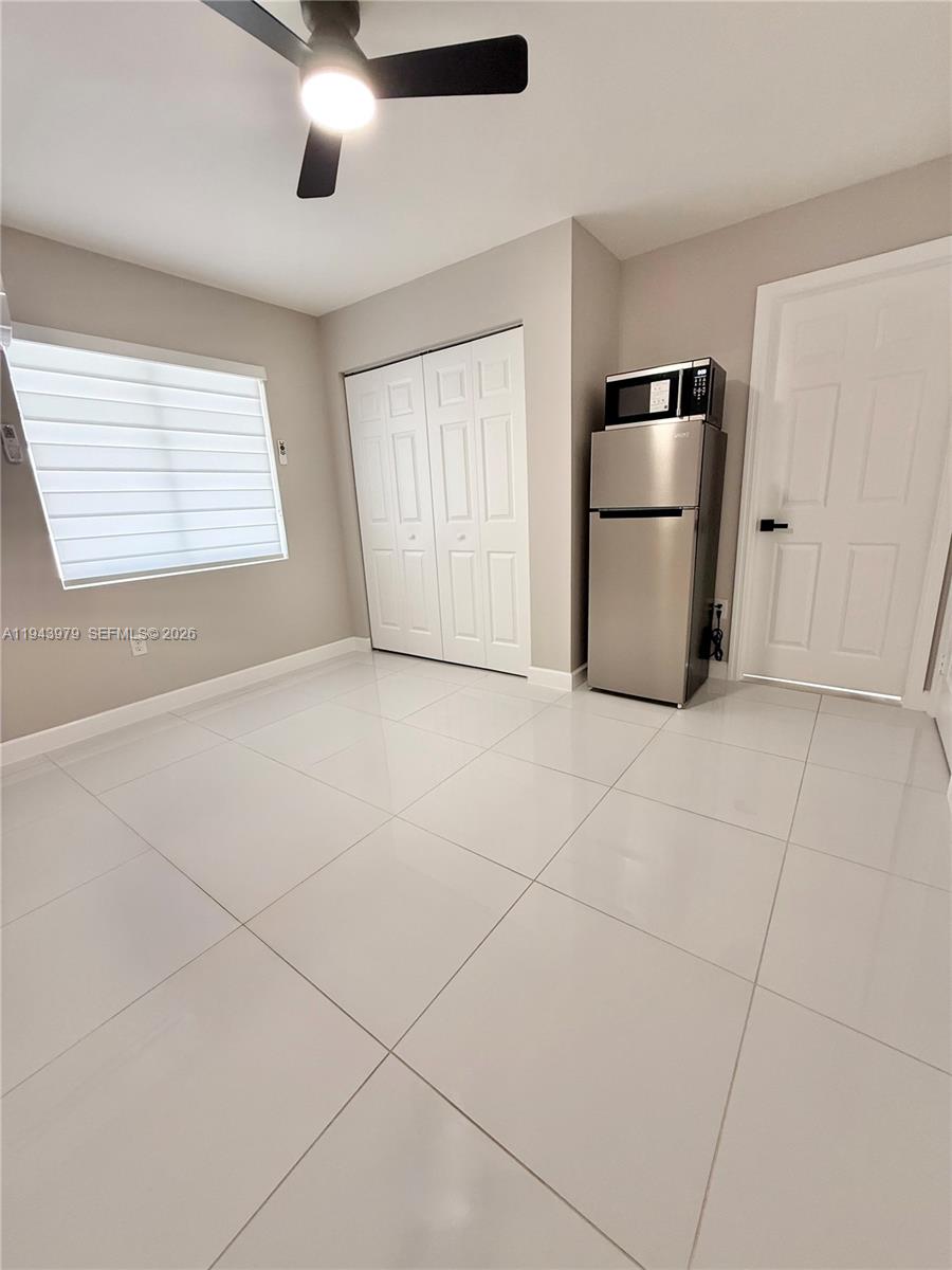 20530 Southwest 316th Street, Unit A Homestead, FL 33030 - Photo 5 of 7 a view of a livingroom with a kitchen and a refrigerator