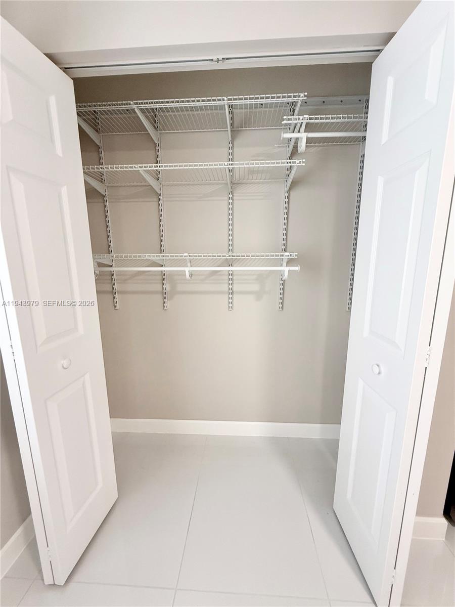 20530 Southwest 316th Street, Unit A Homestead, FL 33030 - Photo 7 of 7 a view of a room with racks on the wall