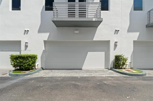 a view of room with wooden floor and a bathroom
