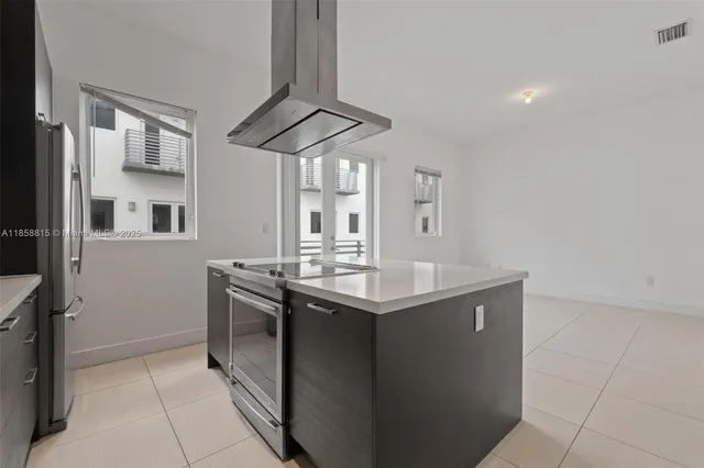 a kitchen with stainless steel appliances granite countertop a sink and cabinets