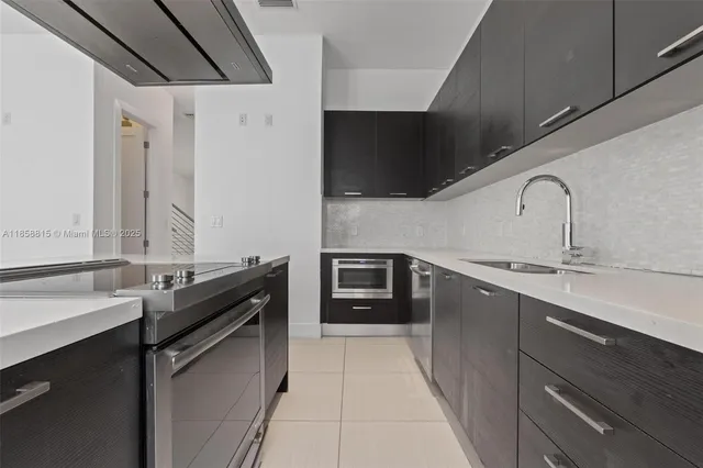 a kitchen with stainless steel appliances a sink and a stove