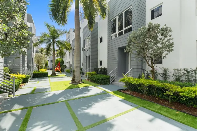 a view of a house with swimming pool and sitting area