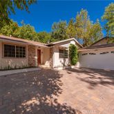 a view of a house with a yard and garage