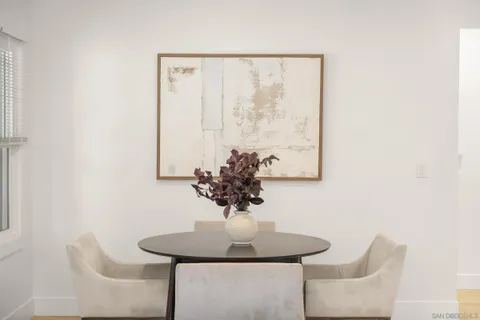 a view of a dining room with furniture and a potted plant