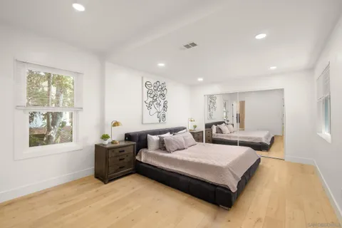 a bedroom with a large bed and a window