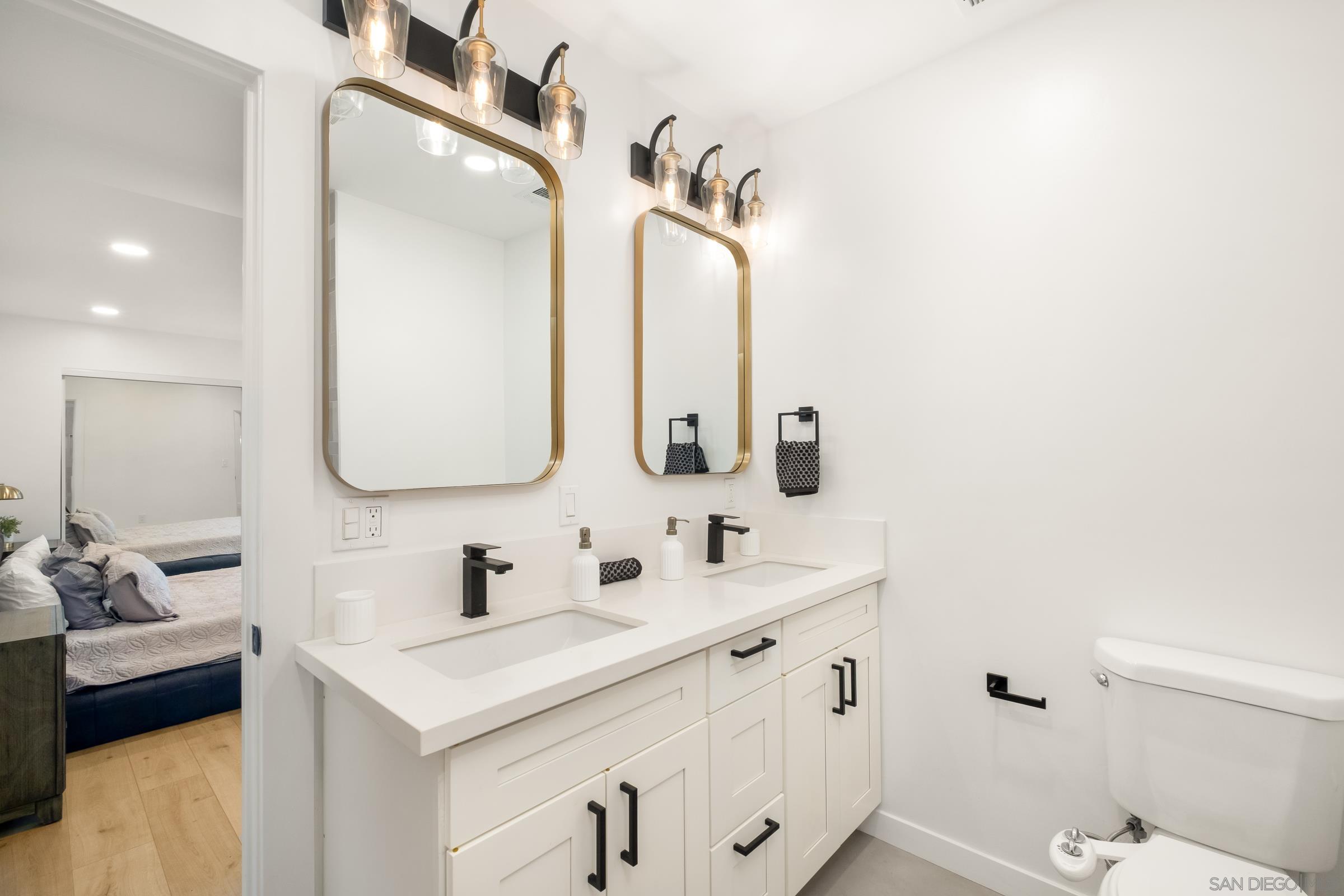 3365 Grim Avenue San Diego, CA 92104 - Photo 22 of 47 a bathroom with a double vanity sink mirror and