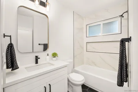 an empty room with a window and a ceiling fan