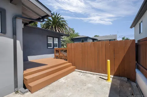 a yellow house with trees in front of it
