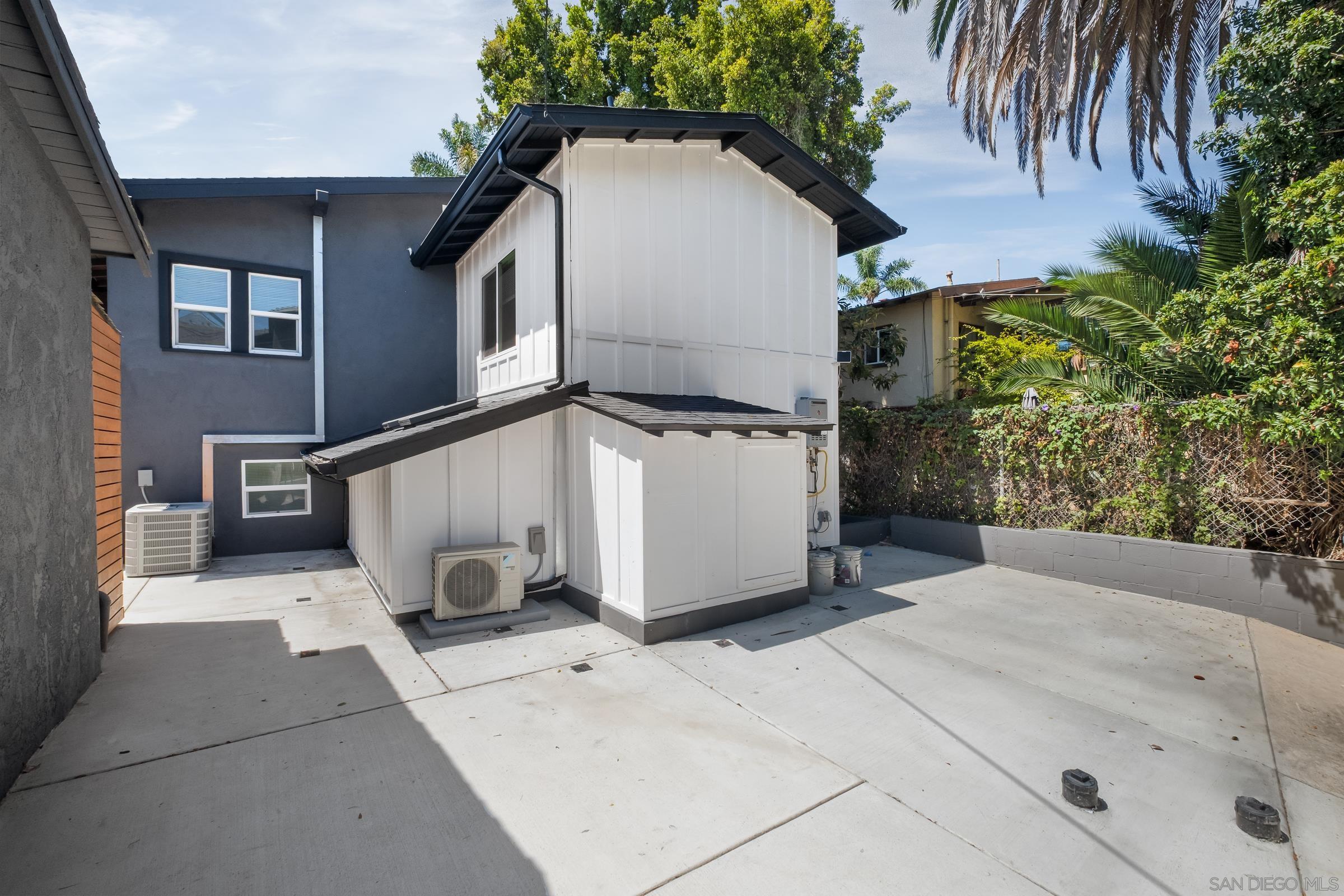 3365 Grim Avenue San Diego, CA 92104 - Photo 33 of 47 a view of a white house with a yard and potted plants