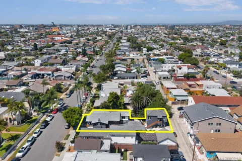an aerial view of a house with a yard and outdoor seating