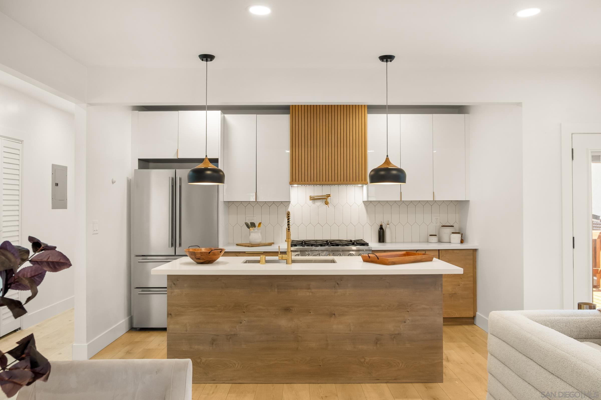 3365 Grim Avenue San Diego, CA 92104 - Photo 7 of 47 a kitchen with kitchen island stainless steel appliances a sink stove and refrigerator