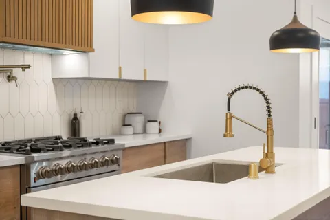 a kitchen with a sink and a stove