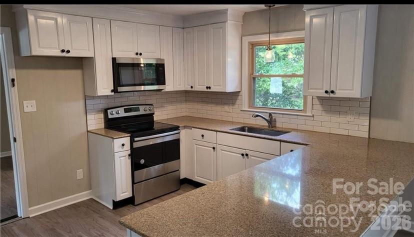 209 Azalea Road Lancaster, SC 29720 - Photo 2 of 4 a kitchen with stainless steel appliances white cabinets and a sink