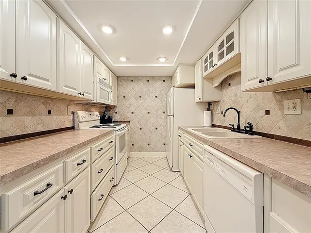 a kitchen with kitchen island a sink table and chairs
