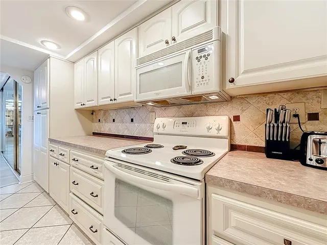 a spacious bathroom with a sink a large mirror and toilet