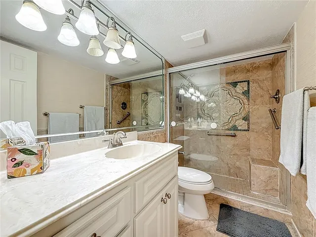 a bedroom with a bed and a tv on the dresser