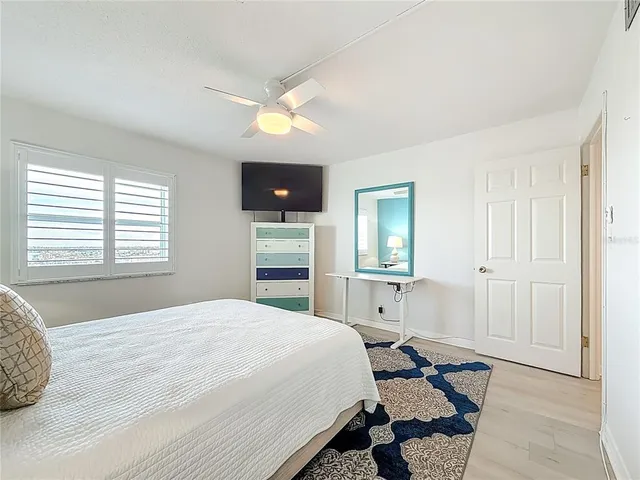 a bedroom with a bed and a lamp on table