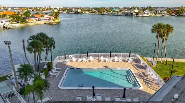 a view of swimming pool with outdoor seating and plants