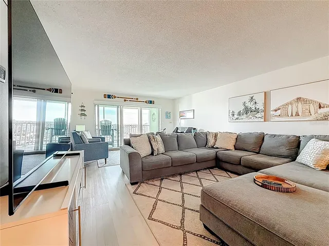 a view of a livingroom with furniture and a window