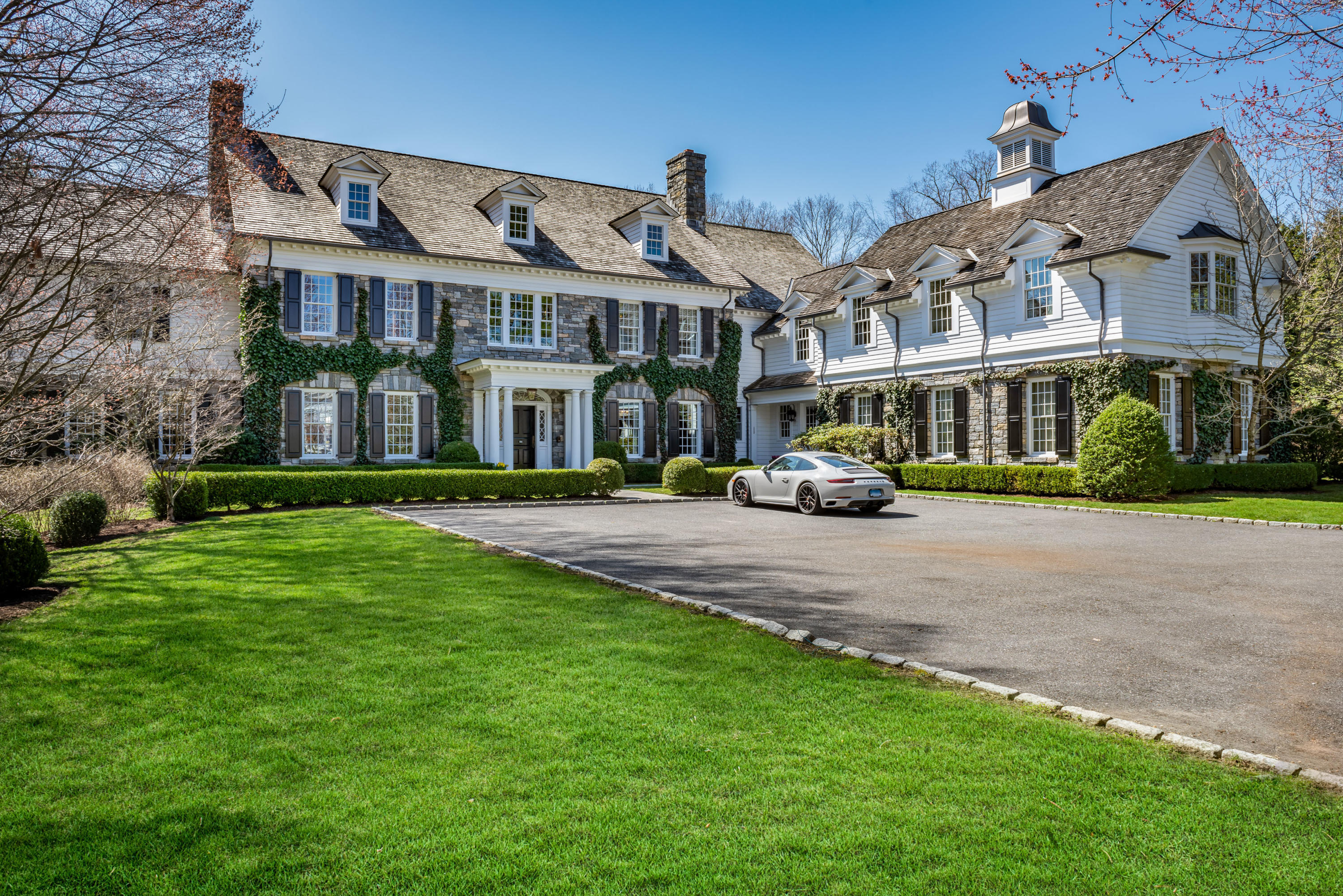 94 Doubling Road Greenwich, CT 06830 - Photo 1 of 26 a front view of a building with a garden