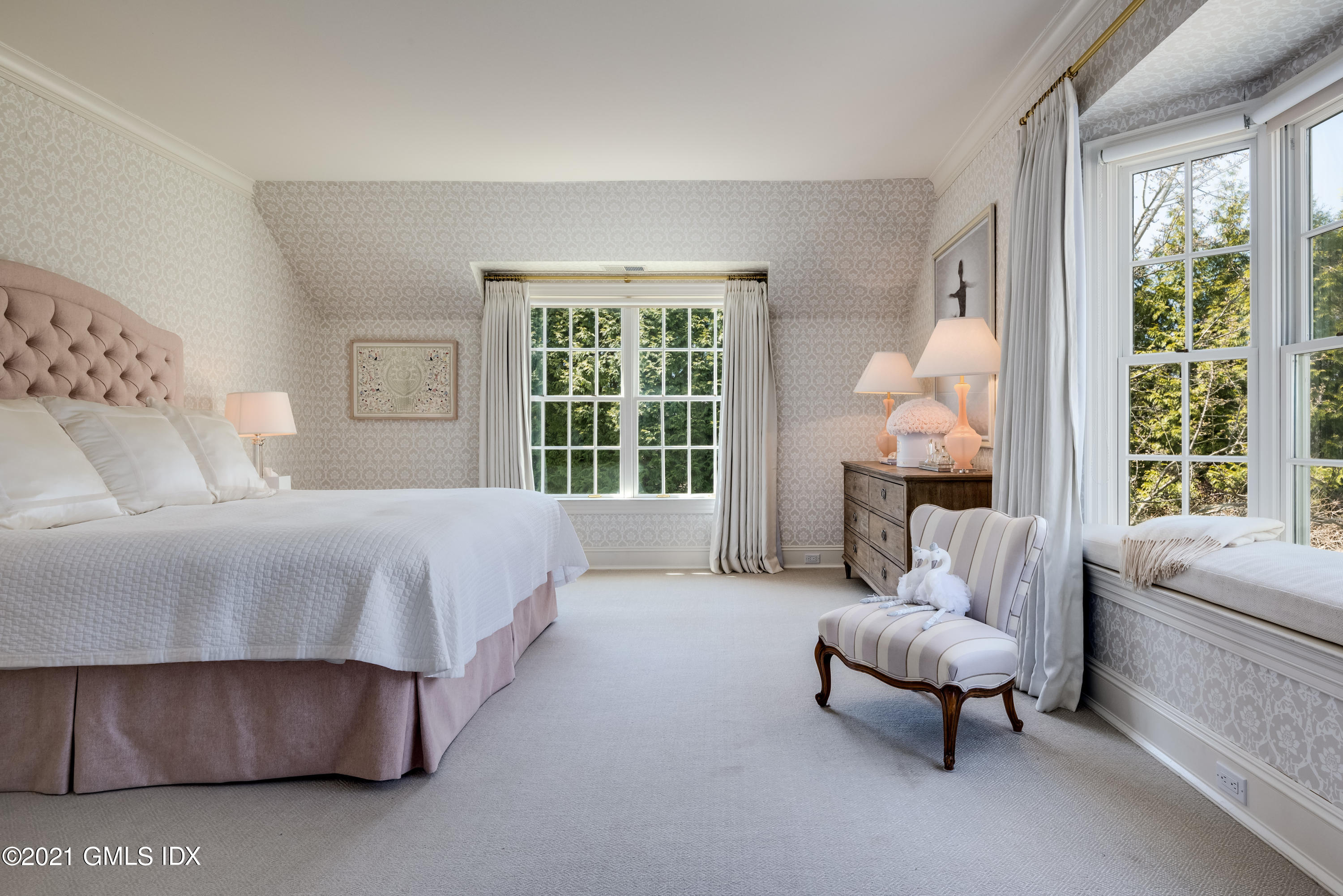 94 Doubling Road Greenwich, CT 06830 - Photo 17 of 26 a spacious bedroom with a bed and a large window