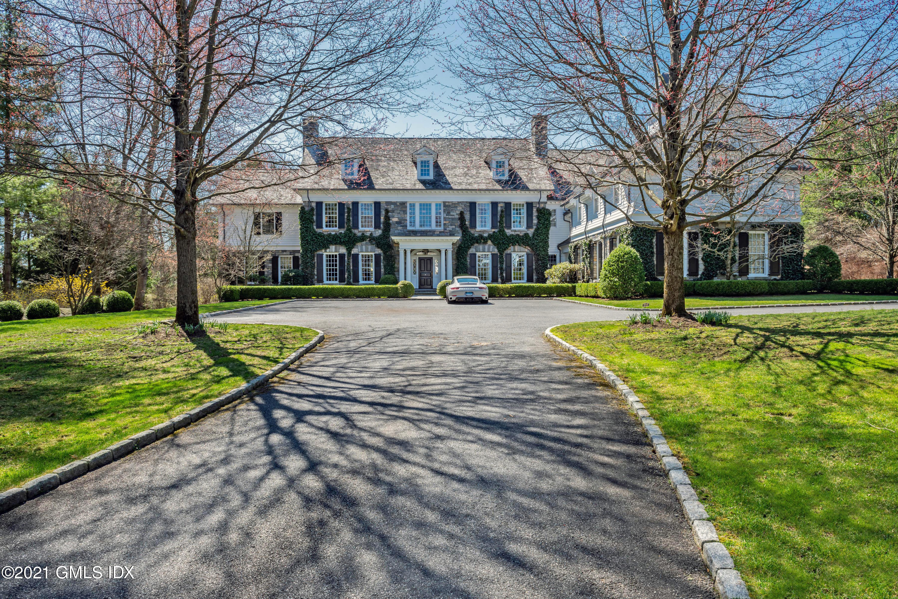 94 Doubling Road Greenwich, CT 06830 - Photo 2 of 26 a front view of a building with a yard
