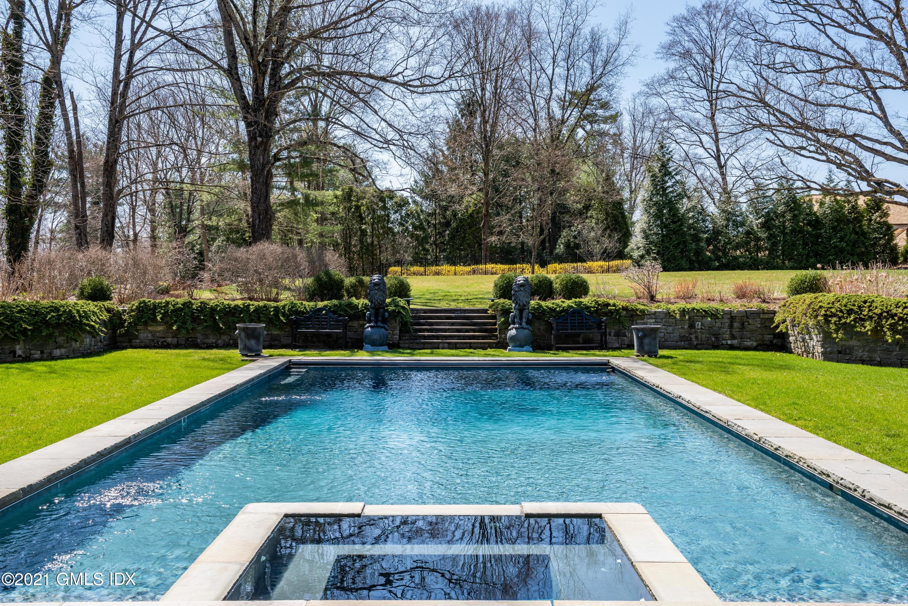 94 Doubling Road Greenwich, CT 06830 - Photo 25 of 26 a view of a swimming pool with a yard and trees