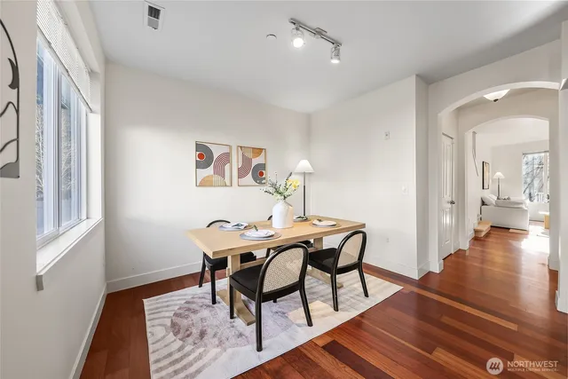 a view of a dining room with furniture and wooden floor