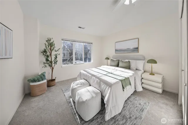 a bedroom with bed and a potted plant