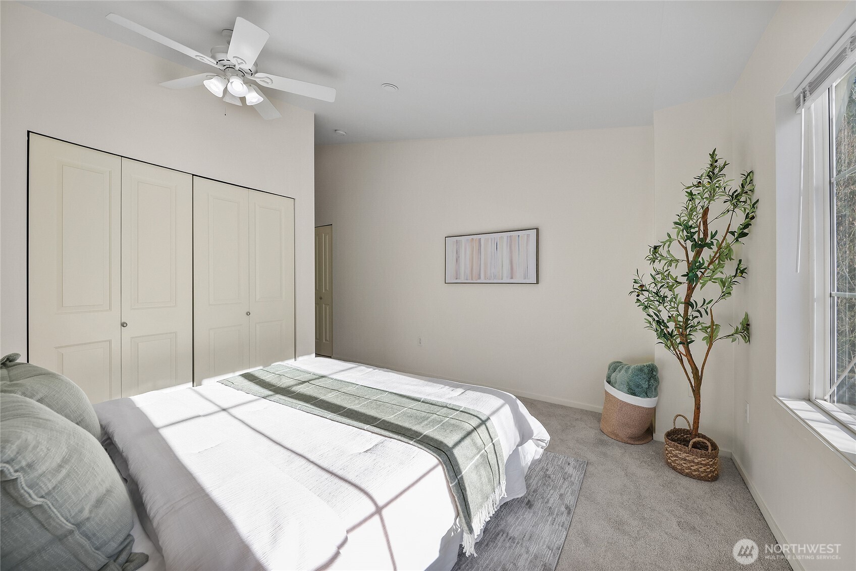 18258 Northeast 96th Way, Unit 101 Redmond, WA 98052 - Photo 18 of 36 a bedroom with a bed and a potted plant