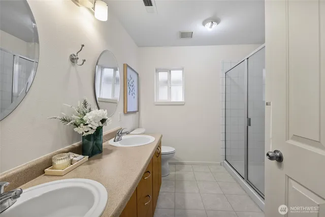 a bathroom with a granite countertop sink a large mirror and a shower