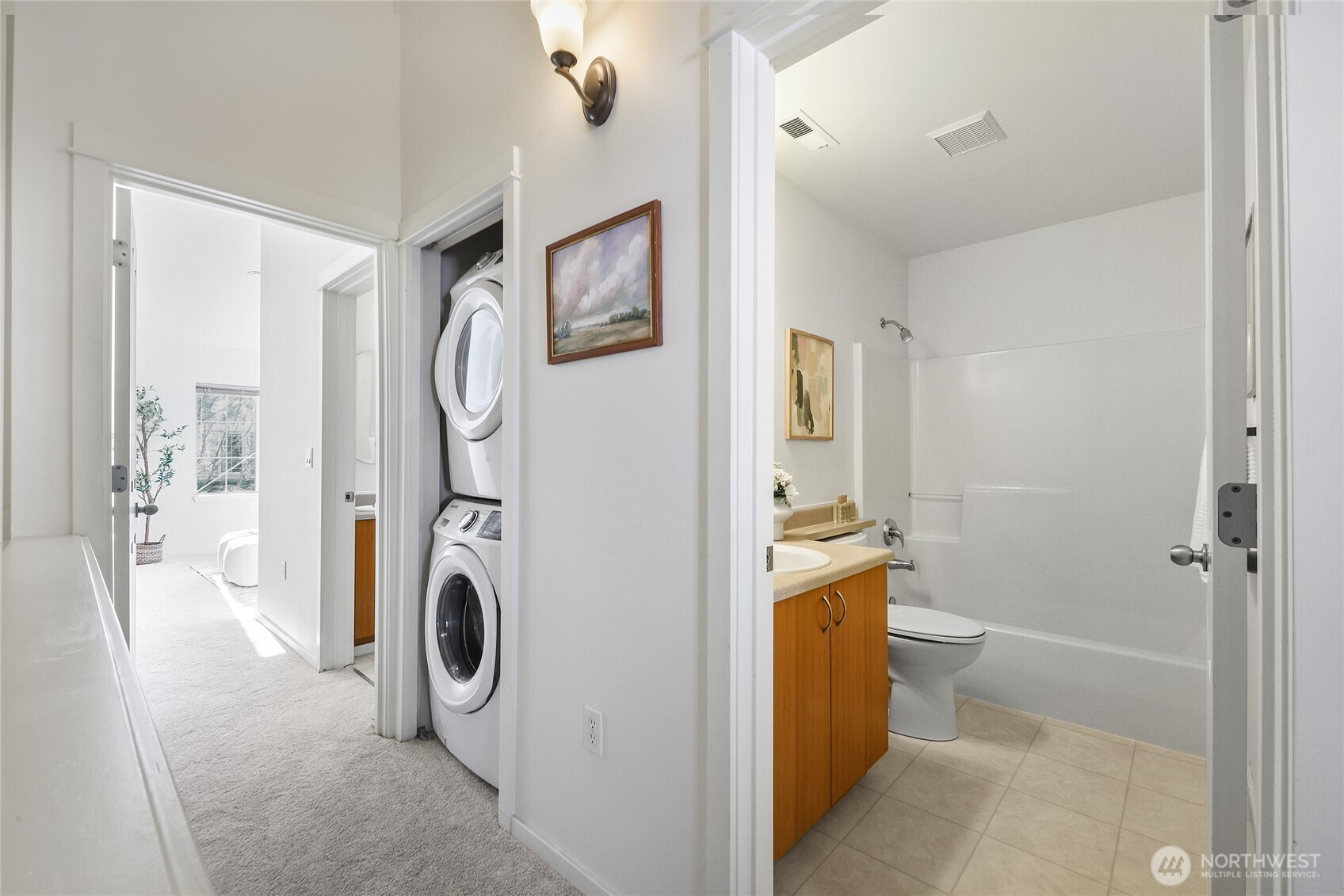 18258 Northeast 96th Way, Unit 101 Redmond, WA 98052 - Photo 22 of 36 a bathroom with a washer and dryer
