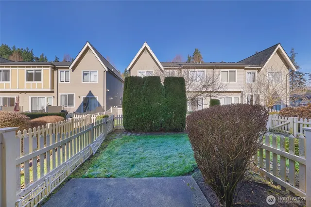 a view of house with a yard and deck