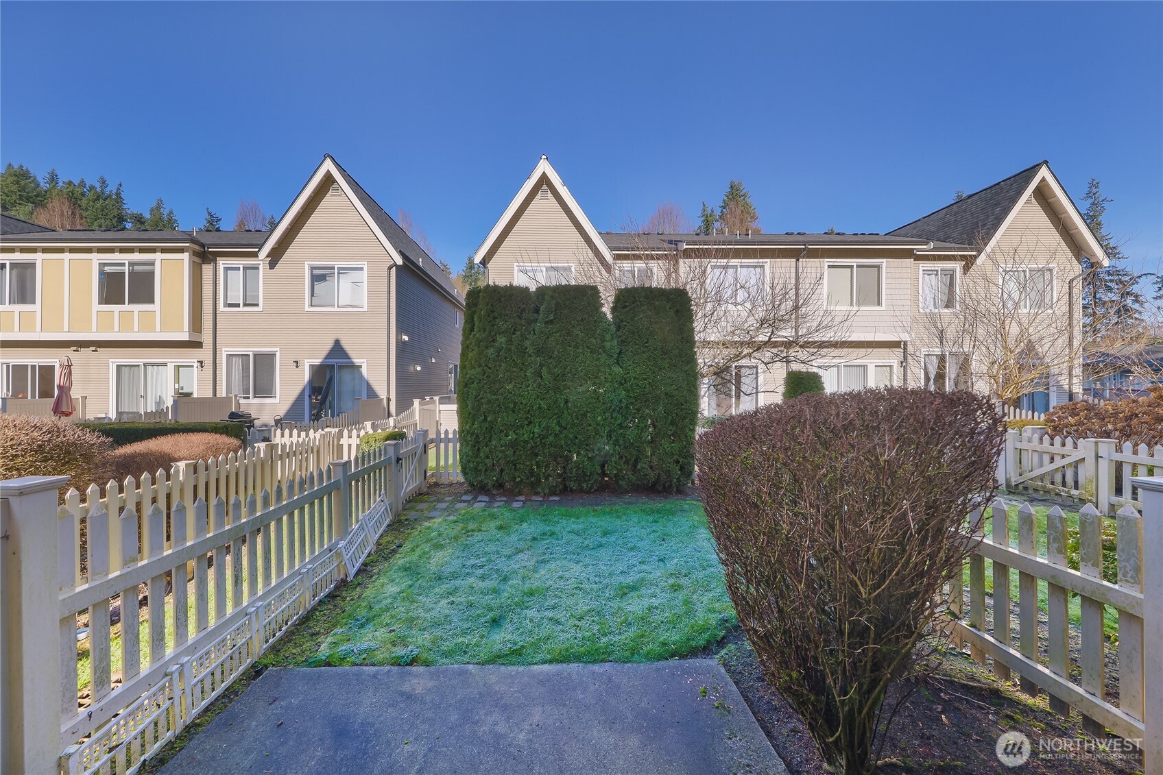 18258 Northeast 96th Way, Unit 101 Redmond, WA 98052 - Photo 26 of 36 a view of house with a yard and deck