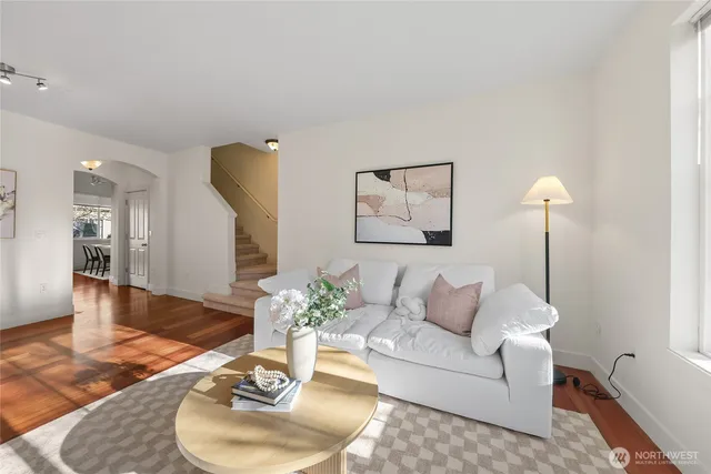 a living room with furniture and a wooden floor