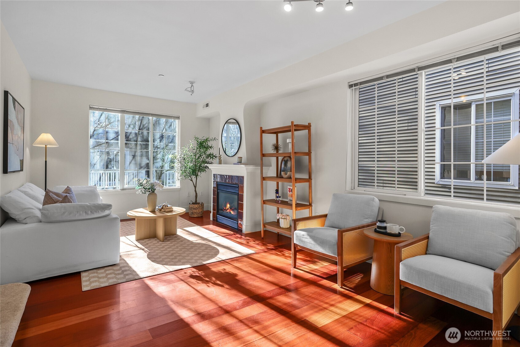 18258 Northeast 96th Way, Unit 101 Redmond, WA 98052 - Photo 6 of 36 a living room with furniture a fireplace and a large window