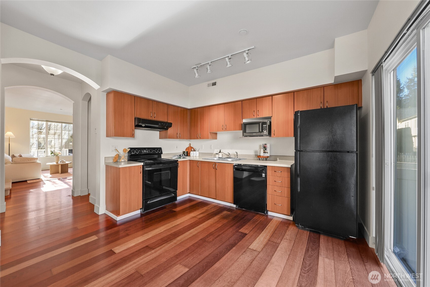 18258 Northeast 96th Way, Unit 101 Redmond, WA 98052 - Photo 9 of 36 a kitchen with a refrigerator and wooden floor