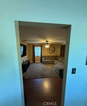 a spacious bedroom with a bed and a flat screen tv