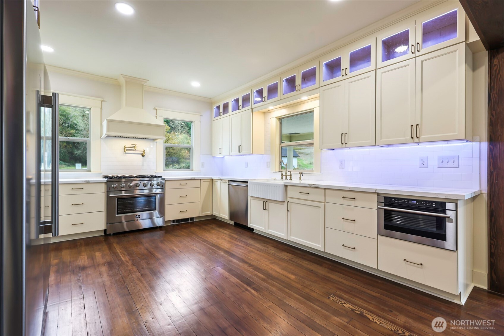 1604 Lincoln Creek Road Rochester, WA 98579 - Photo 18 of 37 a kitchen with stainless steel appliances sink cabinets and wooden floor