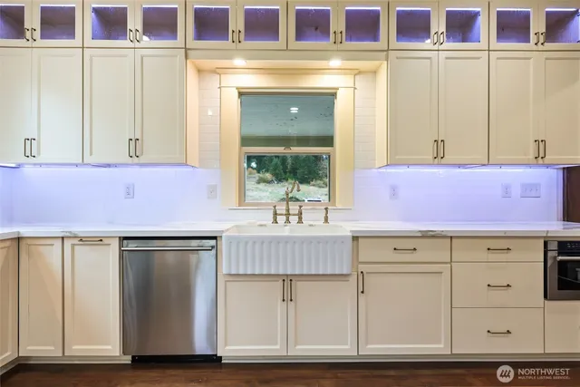 a kitchen with stainless steel appliances a refrigerator and a stove