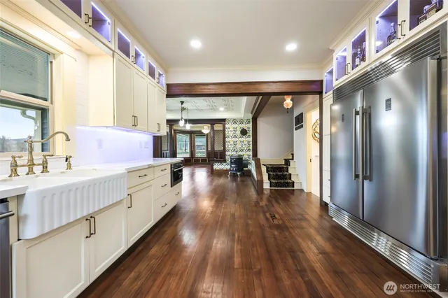 a bed room with wooden floor and windows