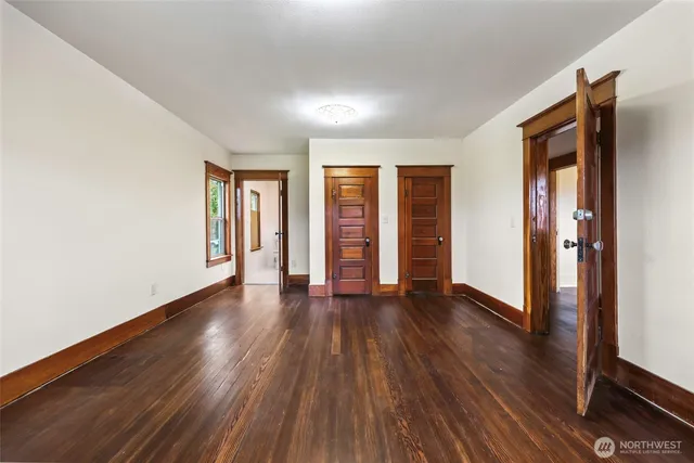 a spacious bedroom with a bed and a window
