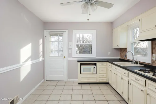 a kitchen with a stove a sink and a refrigerator