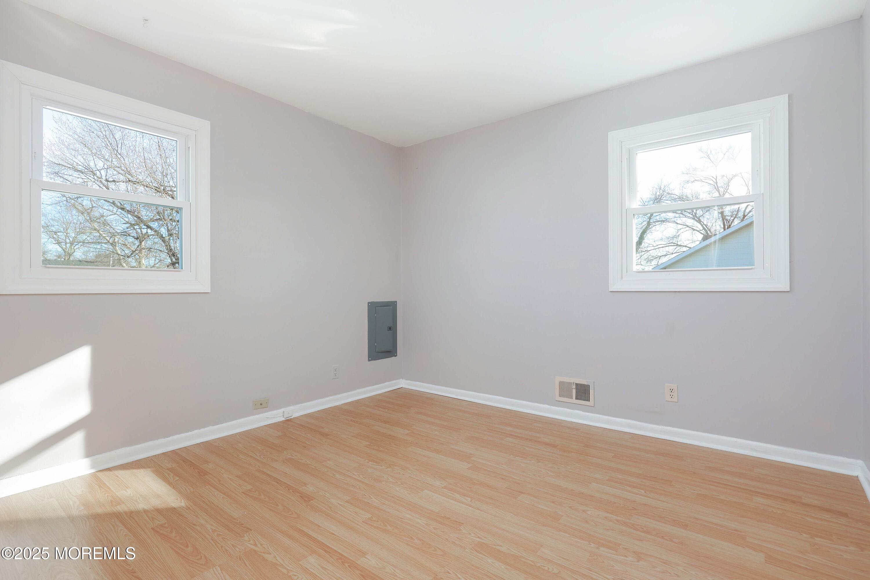 22 Commodore Avenue, Unit B UPPER Keansburg, NJ 07734 - Photo 9 of 20 a view of an empty room with wooden floor and a window